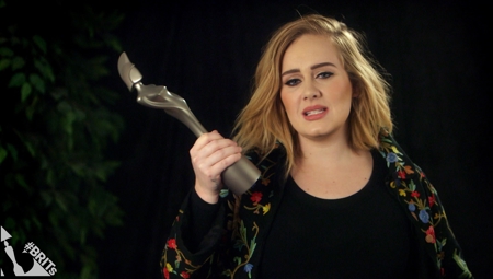 Adele accepts her trophy for BRITs Global Success Award
